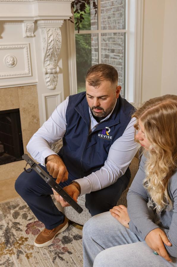 Robert Spence reviewing inspection findings with a homeowner