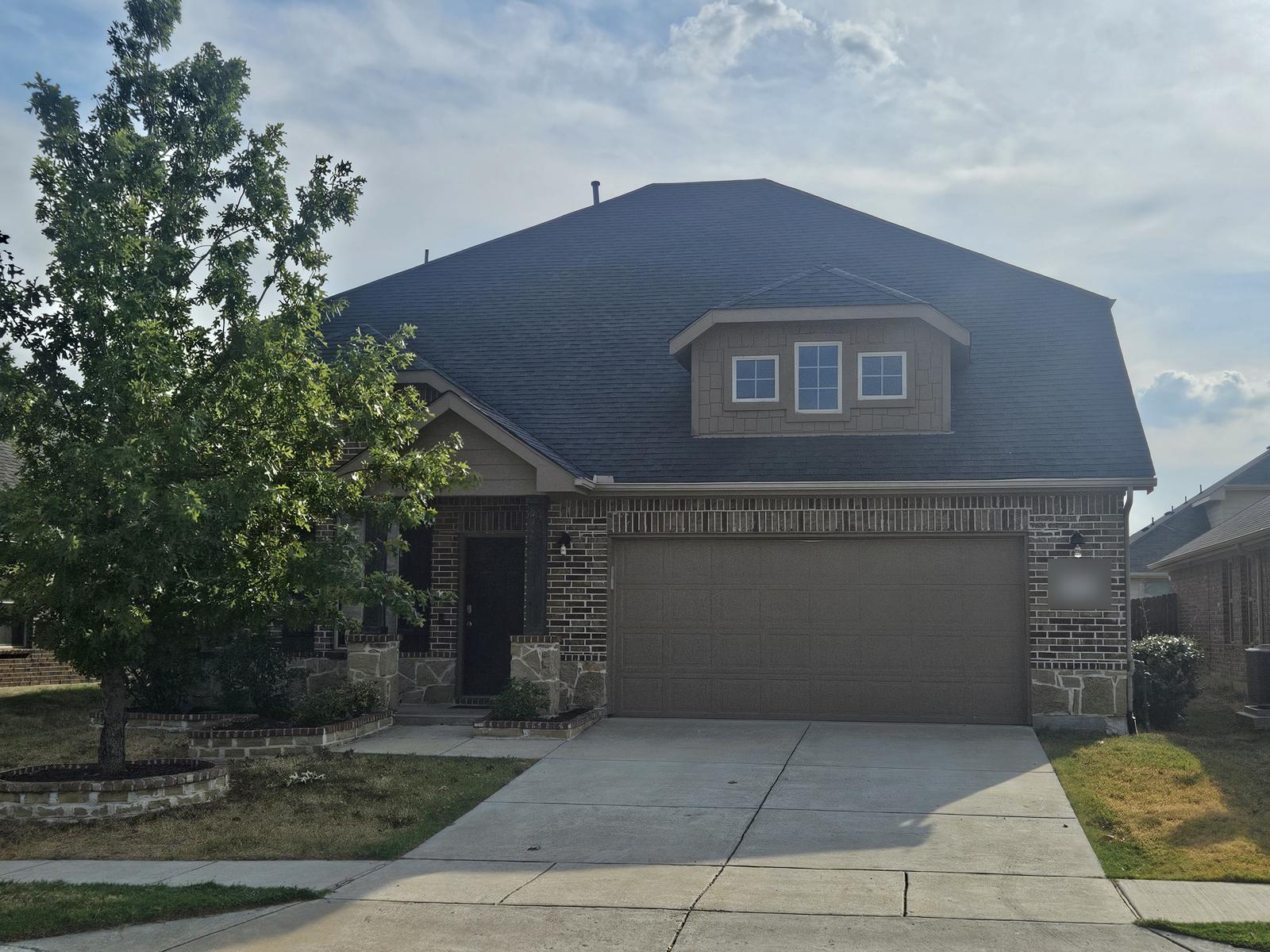 Brick home with a clean two-car garage door
