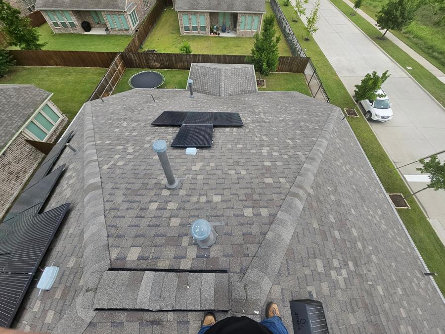 Newly installed dark shingle roof seen from above